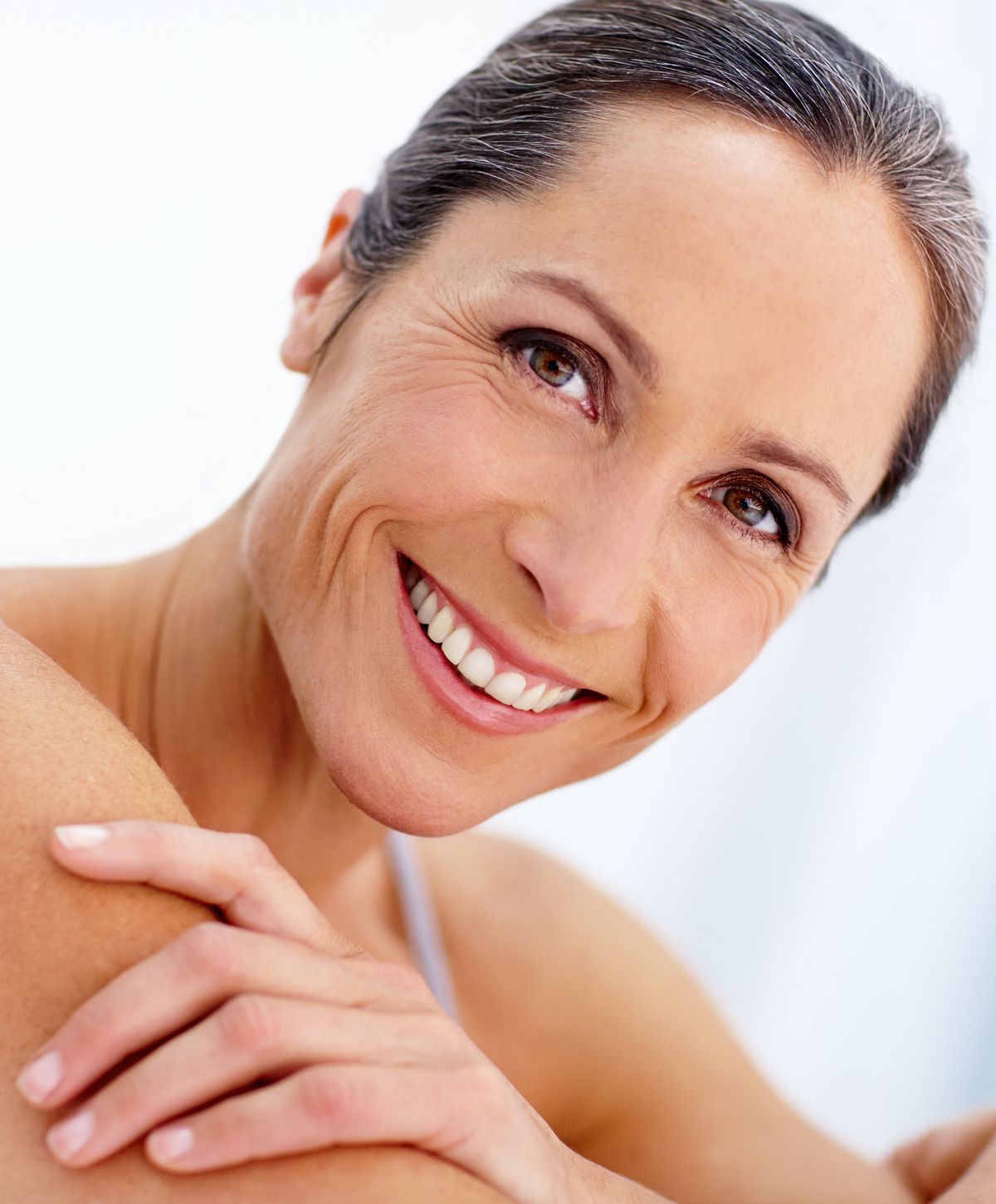 Smiling woman with beautiful skin and radiant expression.