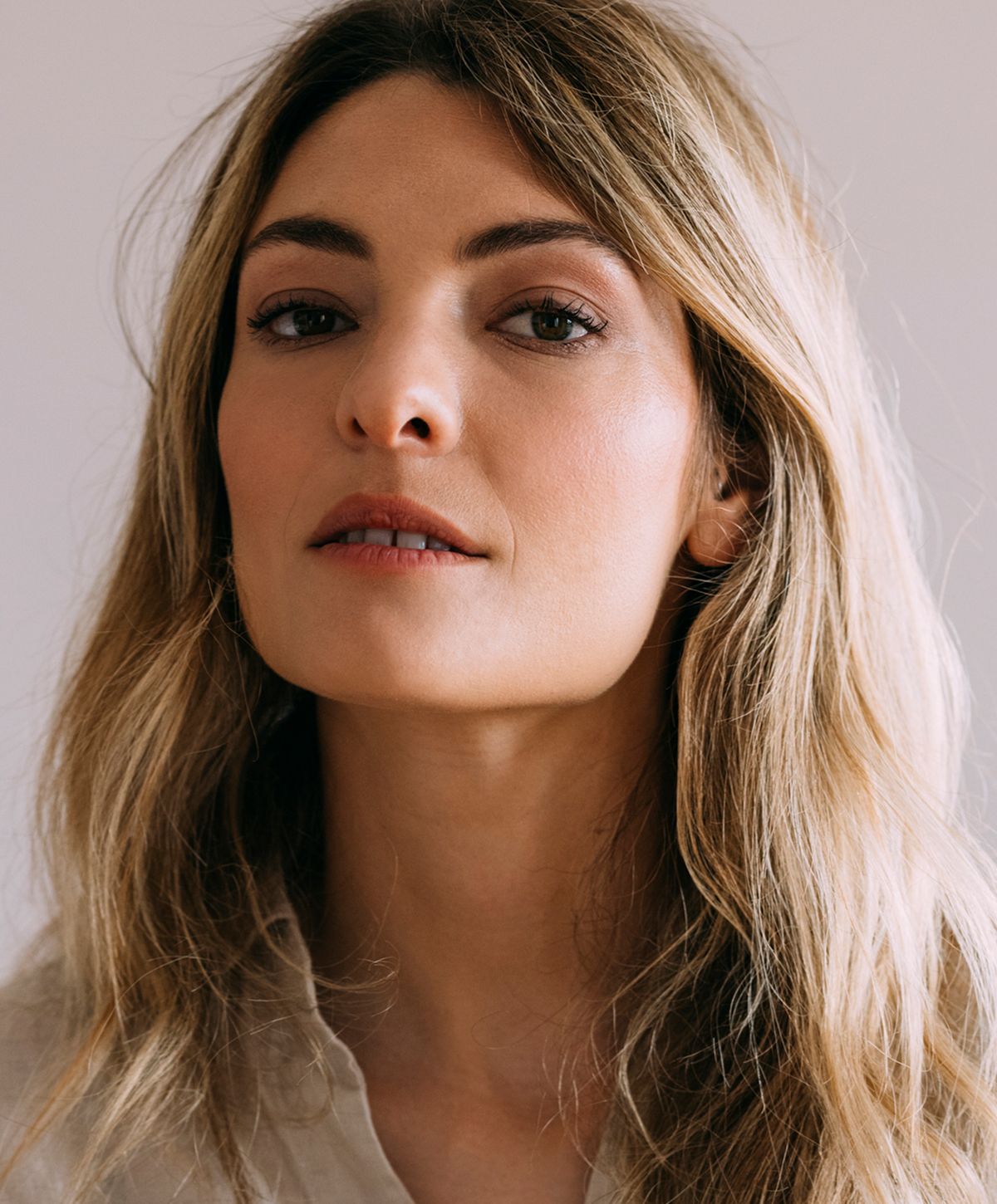 Close-up portrait of a woman with flowing hair.