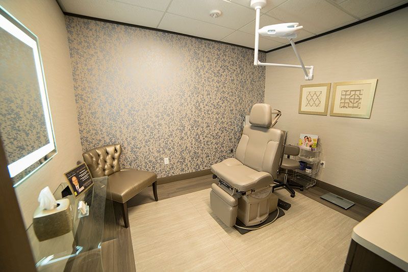 Modern medical exam room with seating area.