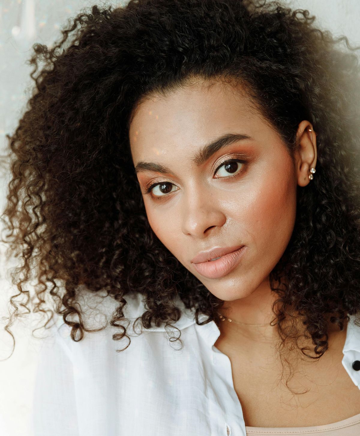 Woman with curly hair and natural makeup