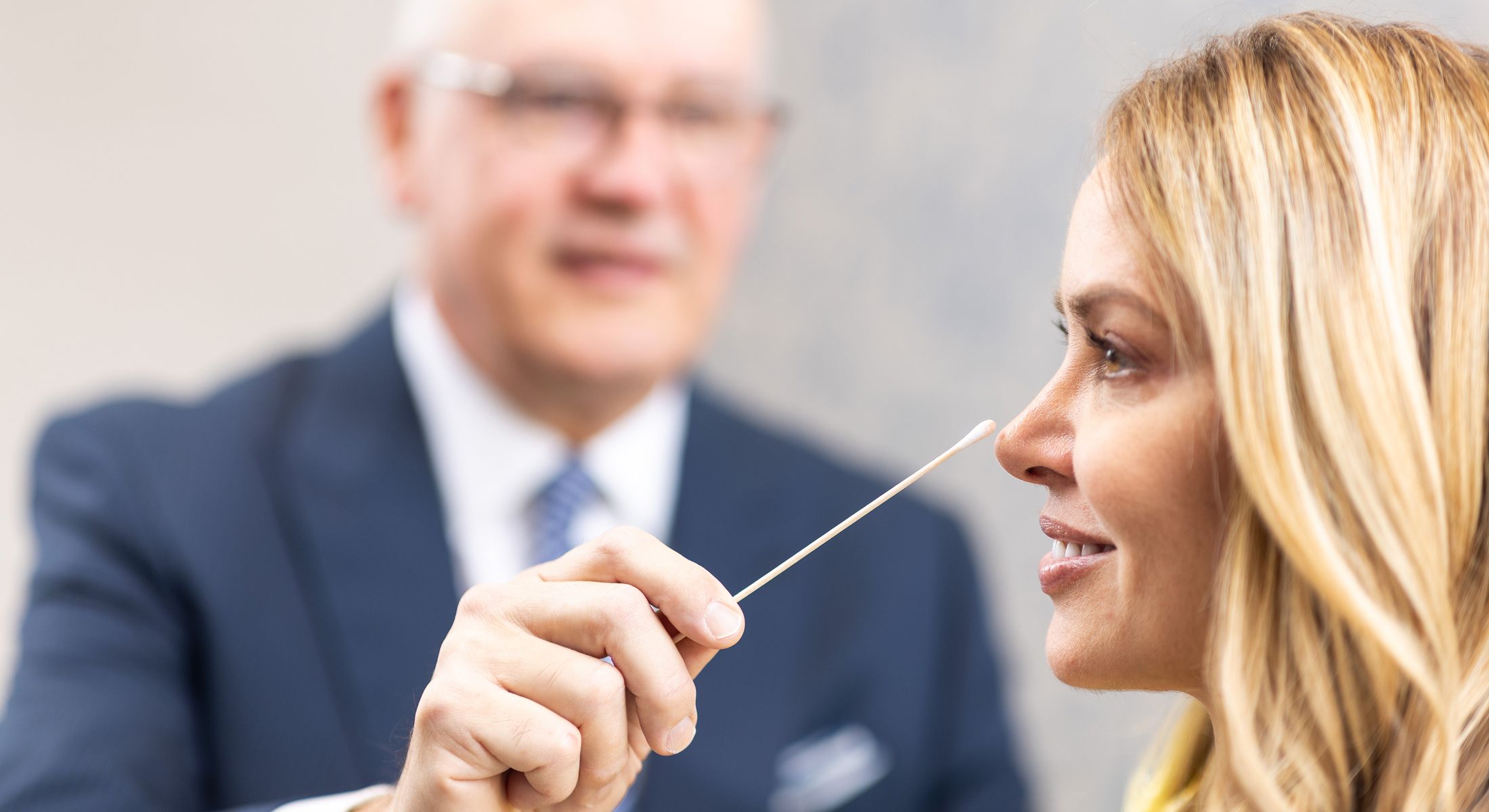 Medical professional administering a test swab.